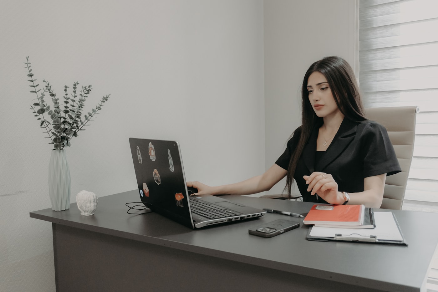 Profissional em ambiente corporativo com laptop.